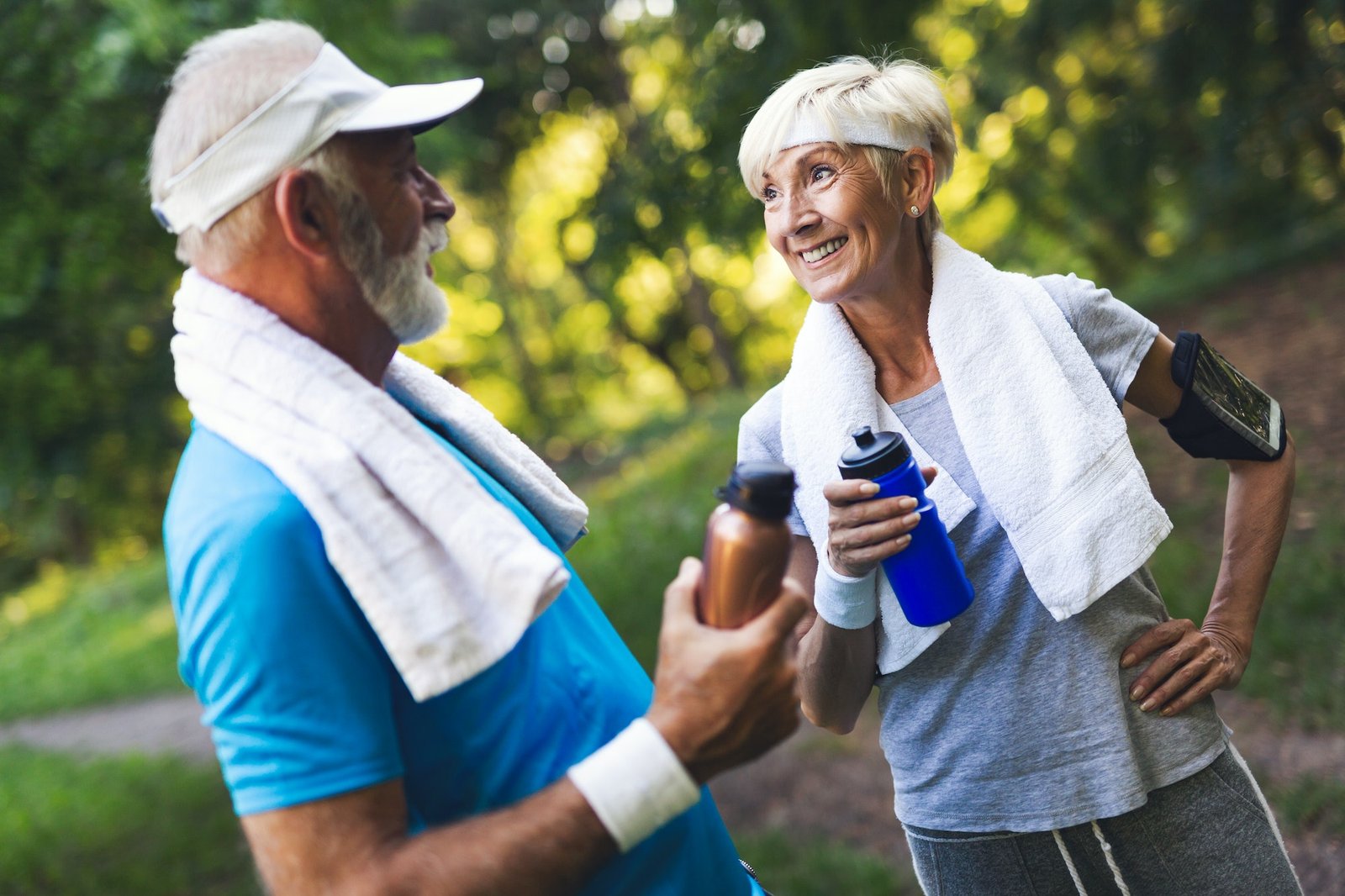 Senior couple jogging and running outdoors in nature
